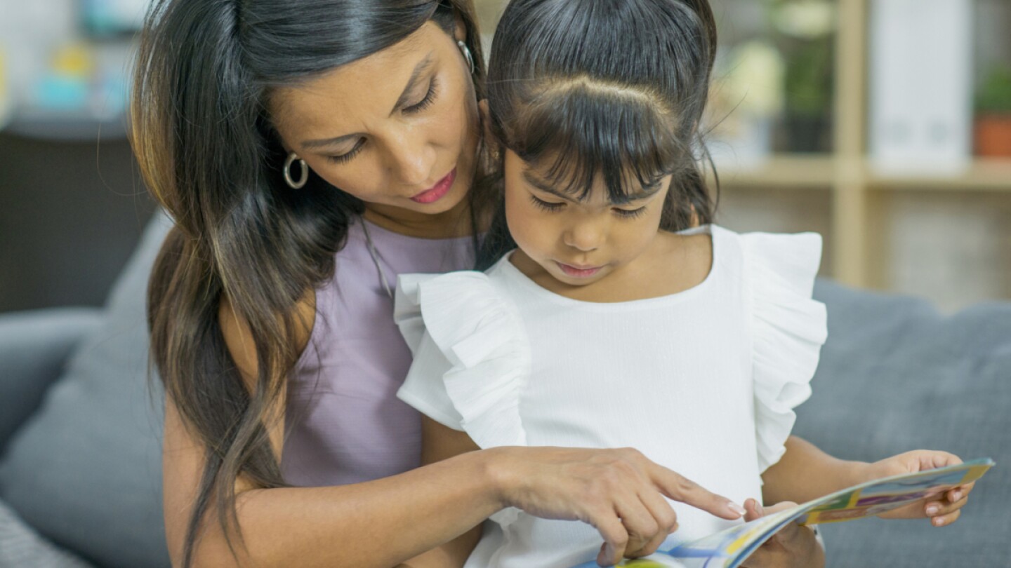 A mother and her daughter read together