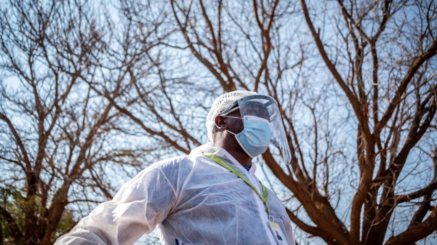A Phlebotomist with the National Health Laboratory Service is pictured outside the Pudumong Healthcare Centre in the North West Province, South Africa, during a routine visit on September 4, 2020. | Thomson Reuters Foundation/Gulshan Khan