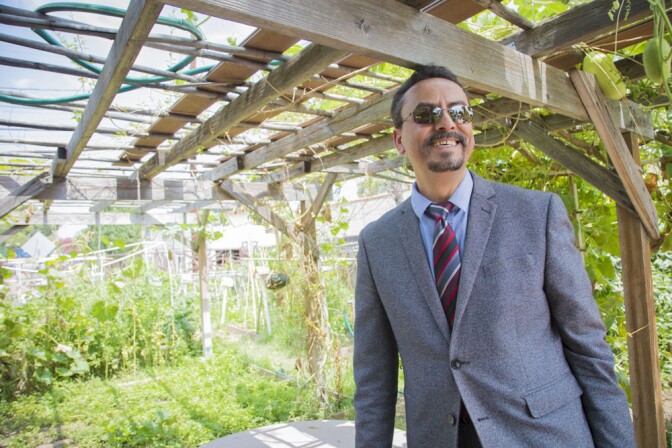 David De La Torre standing at Jardin del Rio community garden.