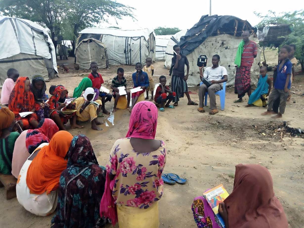 Pupils listen to school lessons broadcast over a solar radio in Dalu village, Tana River County, Kenya, November 28, 2020. | Thomson Reuters Foundation/Benson Rioba