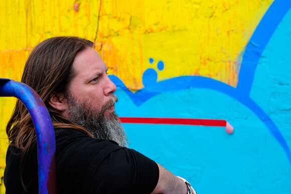 RISK checking out the colors of his mural for Skid Row Housing Trust. | Photo: MOCA.
