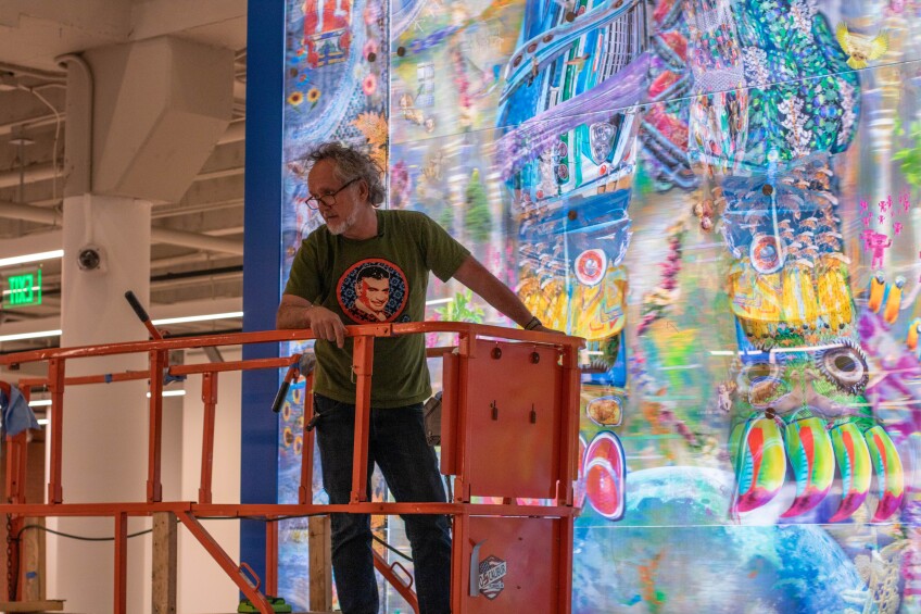 A man stands on the scissor lift.