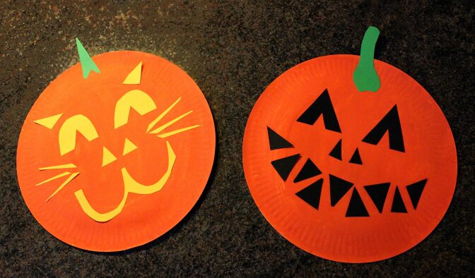 Paper plate crafts decorated to look like jack-o'-lanterns.