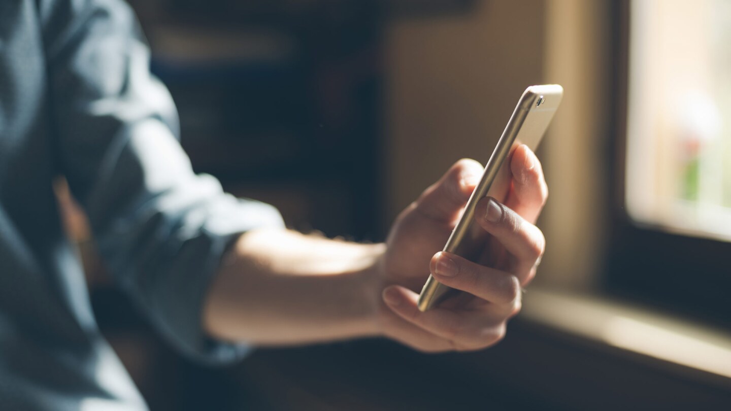 A person records themself on their phone. | iStock via Getty Images