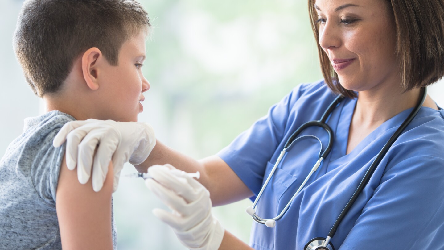 Young Boy Receiving an Immunization Needle stock photo