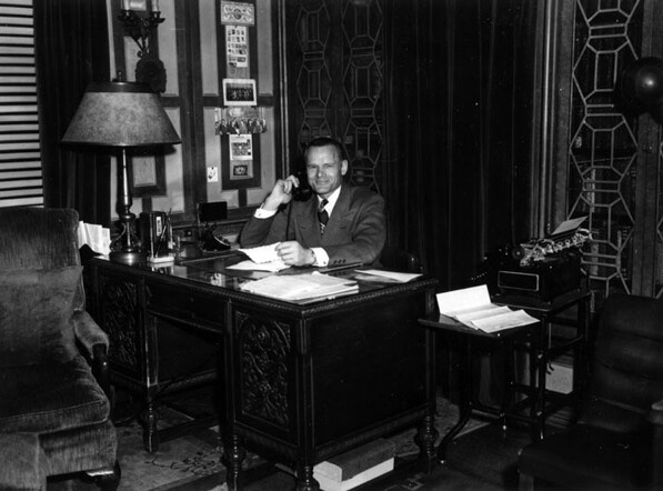 A smiling Clifton's founder Clifford Clinton in his office in 1947. Courtesy of the Los Angeles Public Library Photograph Collection.