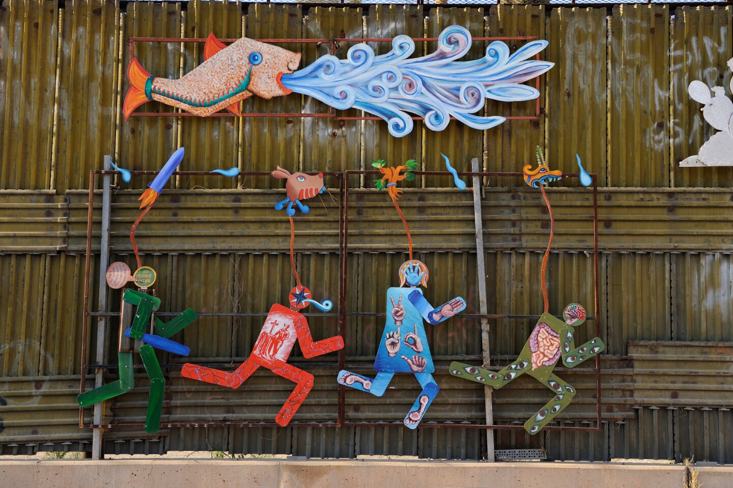 Art on the Mexico/U.S. border fence depicting the struggle between the U.S. Border Patrol and migrants