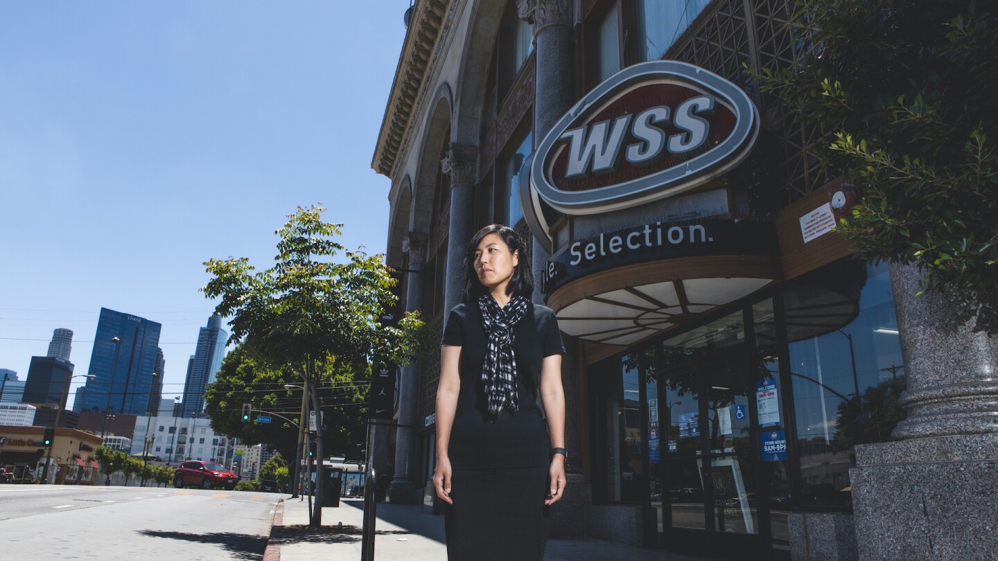 Minah Yeo stands in front of the building where her mother's business burned down during the 1992 civil unrest | Photo by Juhn Kwon