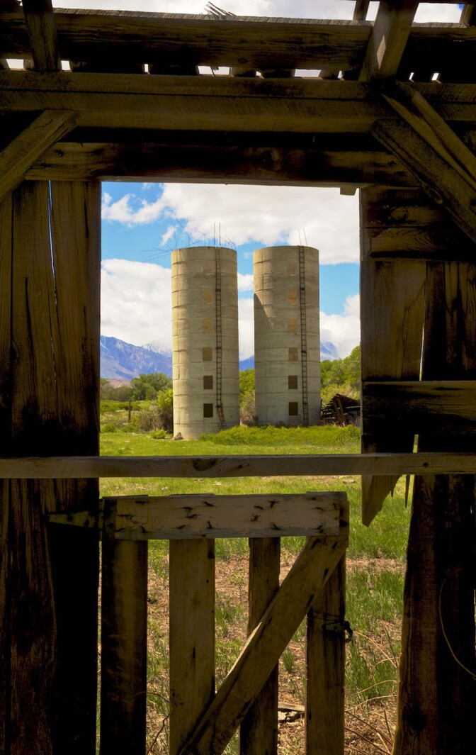 Window View of Twin Silos from Abandoned Barn - Bishop, CA - 2016 | Osceola Refetoff