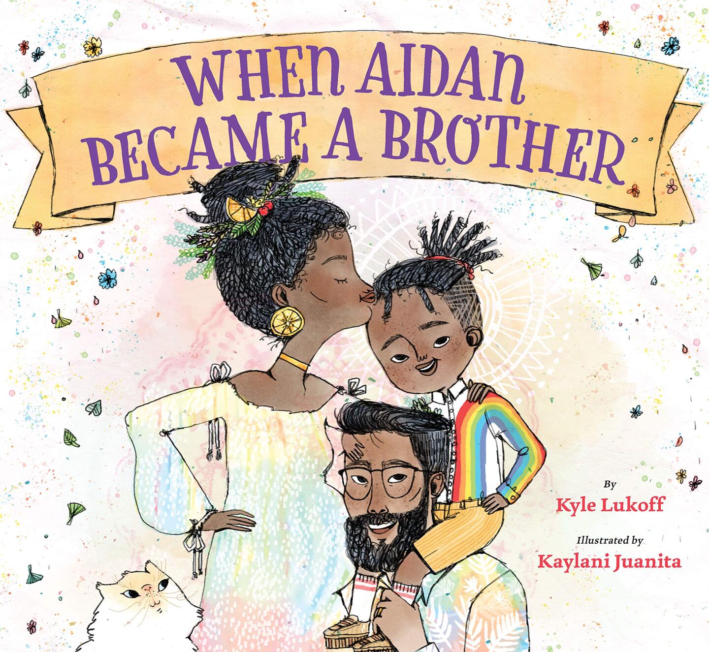 Book cover of “When Aidan Became a Brother” written by Kyle Lukoff and illustrated by Kaylani Juanita featuring an illustration of a Black family. The father is holding a child in a rainbow shirt on his shoulders while the mom is kissing the child's forehead.