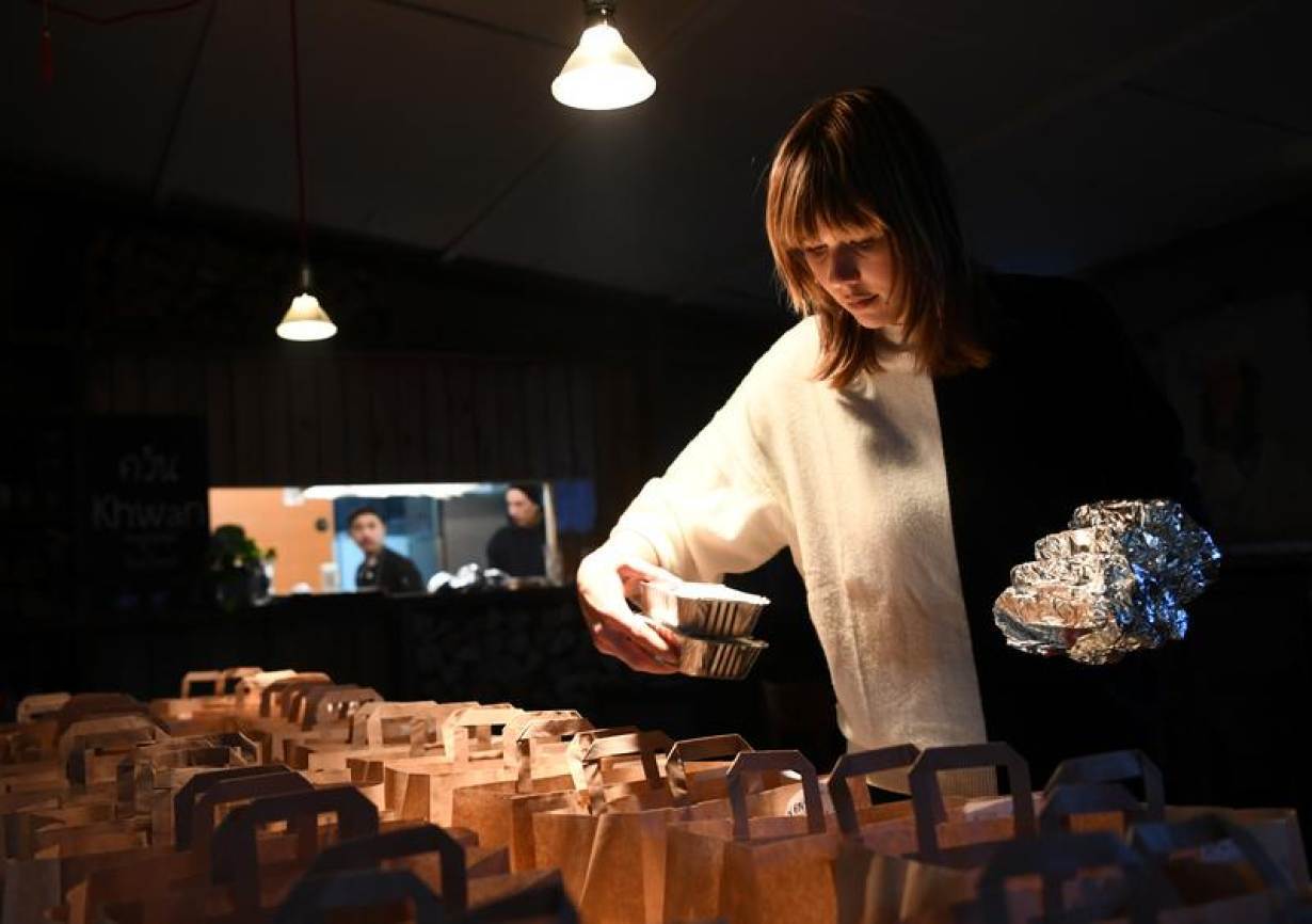FILE PHOTO: Restaurant staffer Natalie prepares orders for take out and delivery at a restaurant called khwan in district Friedrichshain, Berlin, Germany, March 14, 2020.