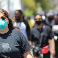 Woman wearing a face mask, walking | Karen Foshay