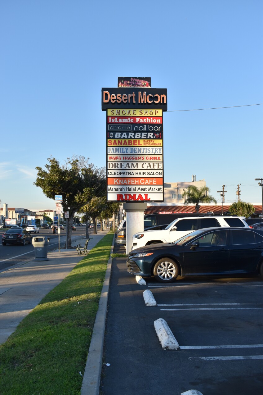 Signs for shops at a strip mall