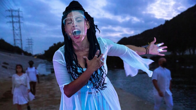 Performers on the banks of the Los Angeles River. The performance is part of at "Firefly Nights," an in-person COVID-safe experience that falls within the "Rio Reveals" series.