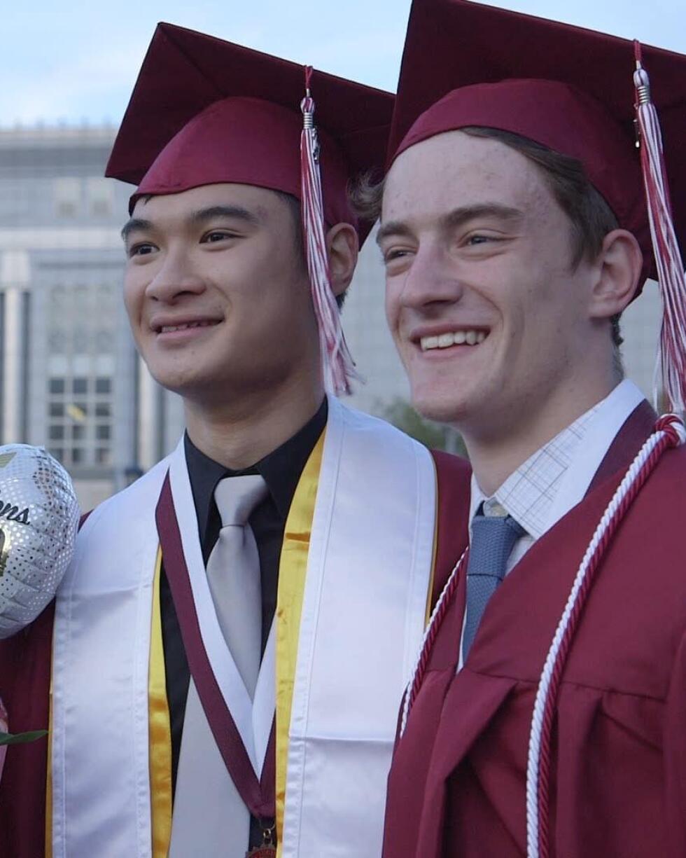 Two Lowell High School graduates standing side by side.