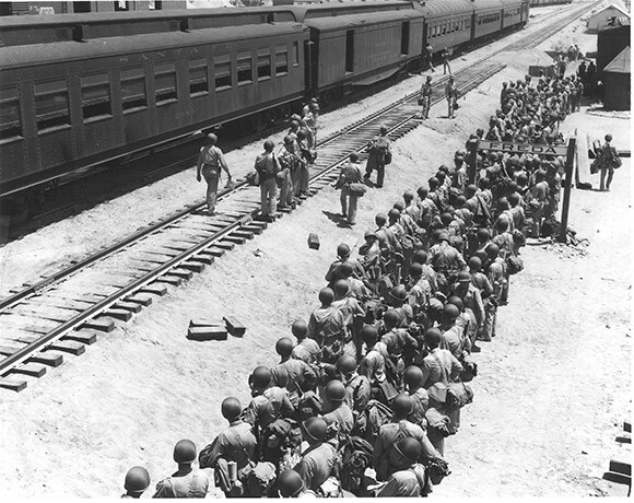 Soldiers disembark at the Freda railroad siding, off what is now Highway 62. Established railroad lines made the Desert Training Center ideal for transporting troops and equipment. U.S. Army photograph | Courtesy of the General Patton Memorial Museum.