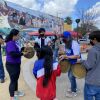 A group plays hand drums in front of "Gintong Kasaysayan," a mural that pays tribute to Filipino Americans.