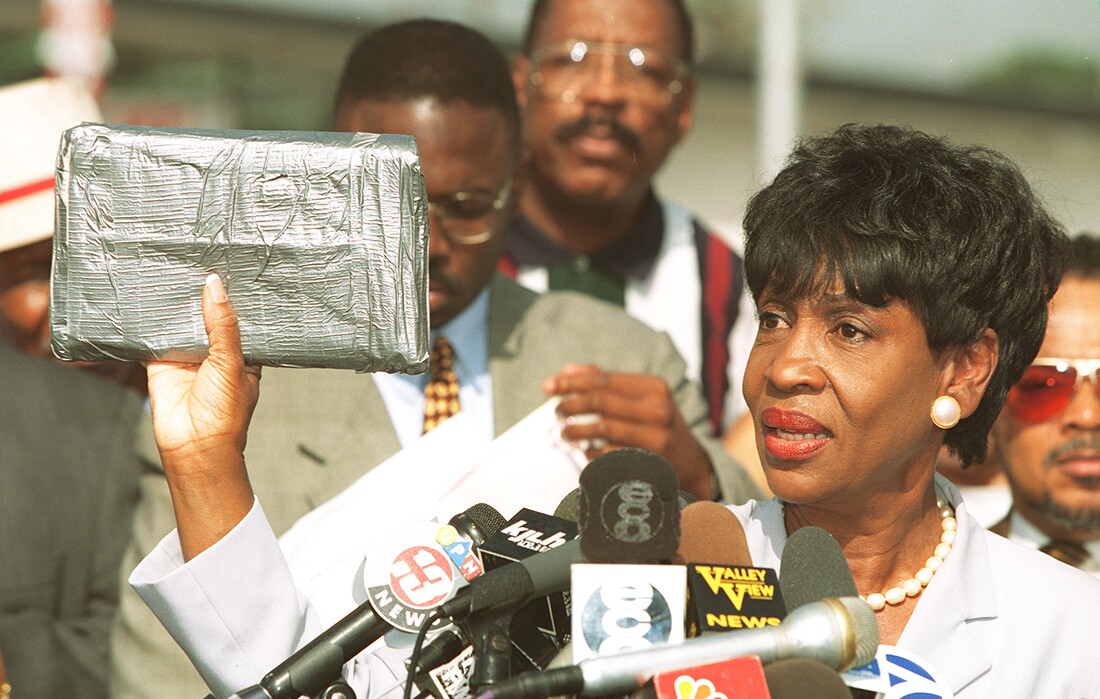 Congresswoman Maxine Waters at a press conference in South Central LA in 1996. She's holding up a taped package that shows how big a kilo of cocaine is. | Rick Meyer/Getty Images