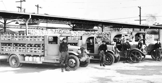 View of Arrowhead Water Company trucks and drivers, 1930-1940