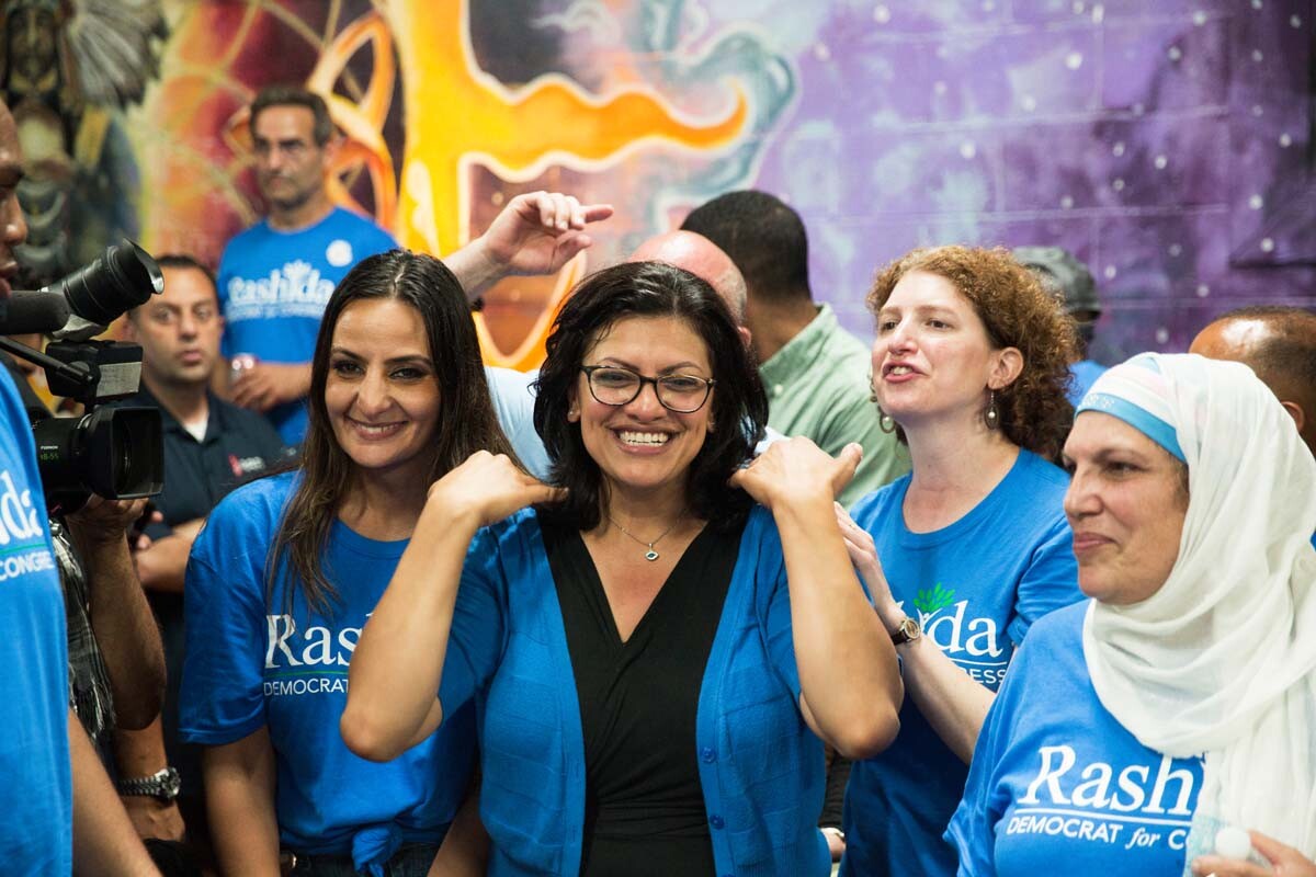 Rashida Tlaib, surrounded by her family and friends celebrates at her 2018 midterm primary election watch party, in Detroit, Michigan. | Erik Howard
