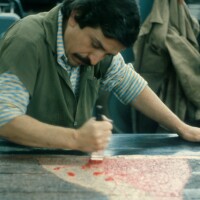 Master printer inking plate at Mixografia, 1979