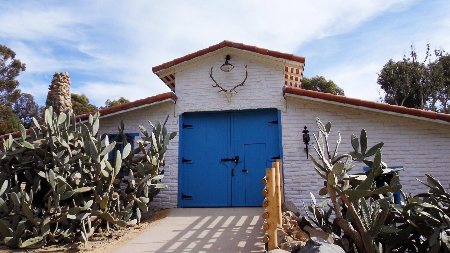 Shot of a barn with blue barndoors at the Leo Carrillo Ranch Historic Park.