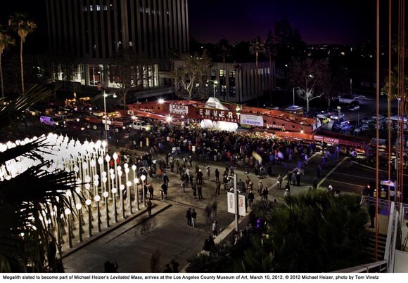 Megalith slated to become part of Michael Heizer's 'Levitated Mass,' arrives at Los Angeles County Museum of Art, March 10, 2012. © 2012 Michael Heizer, photo by Tom Vinetz. Chris Burden's 'Urban Light' is in the foreground to the lower left.