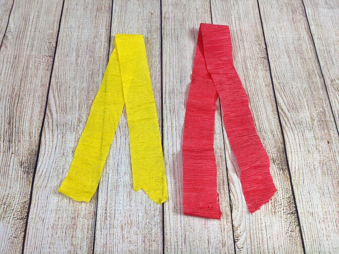 Two pieces of streamer paper, one yellow and the other red.