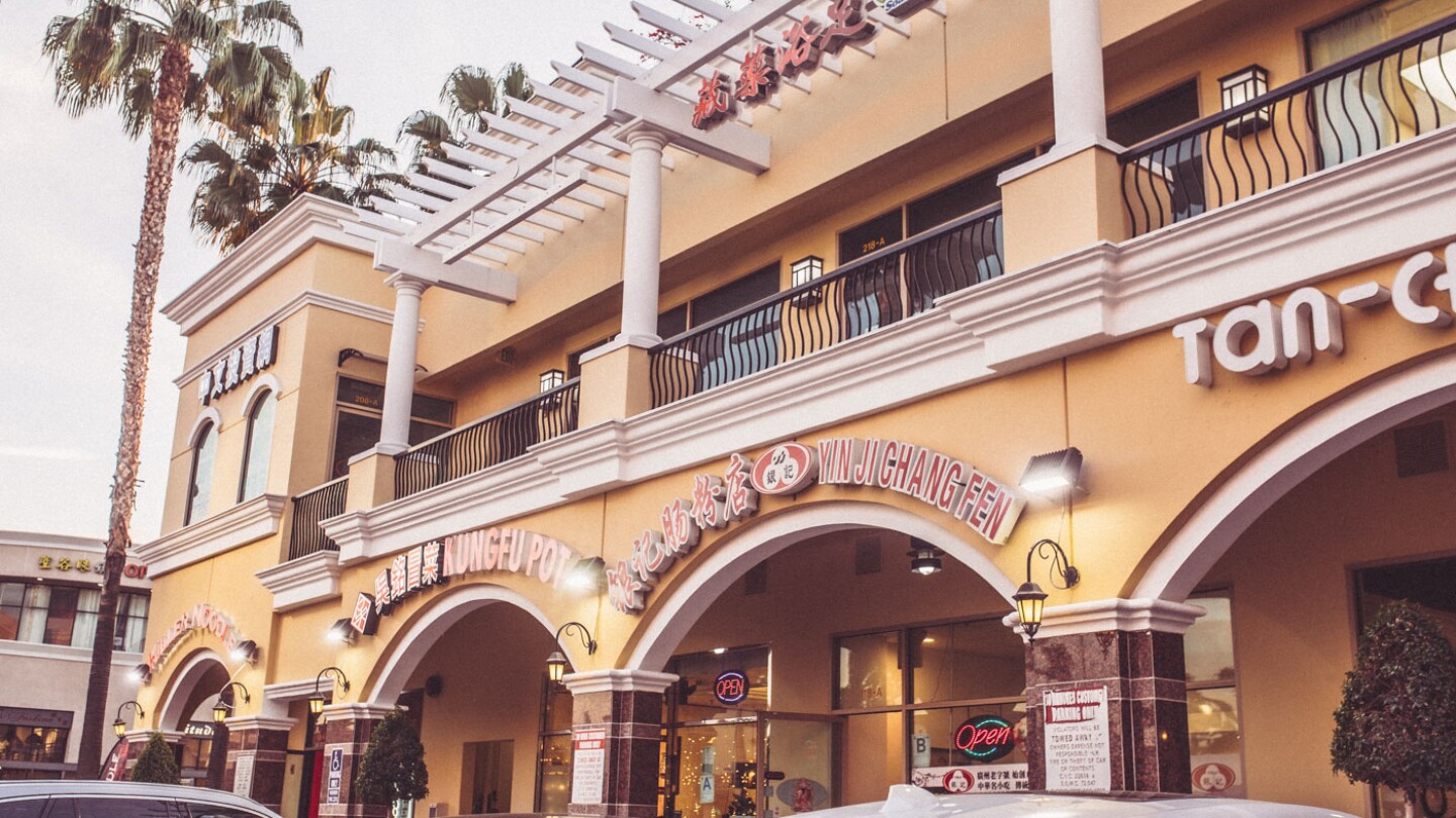 A strip mall with Asian language signs