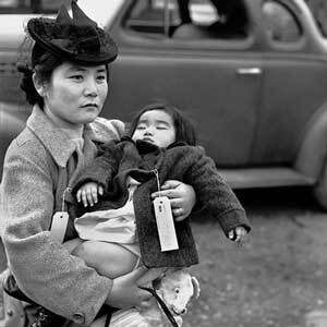 Fumiko Hayashida, 31, carries her daughter, Natalie Kayo, 13 months, as she prepares to board the ferry at Bainbridge Island, Washington. | Post-Intelligencer Collection, Museum of History & Industry