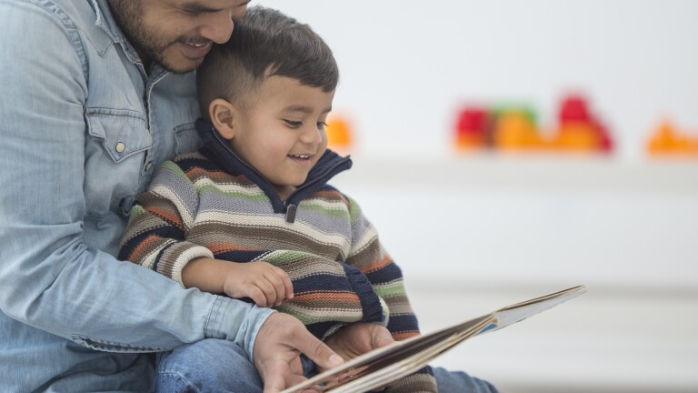 Father Reading His Son a Book