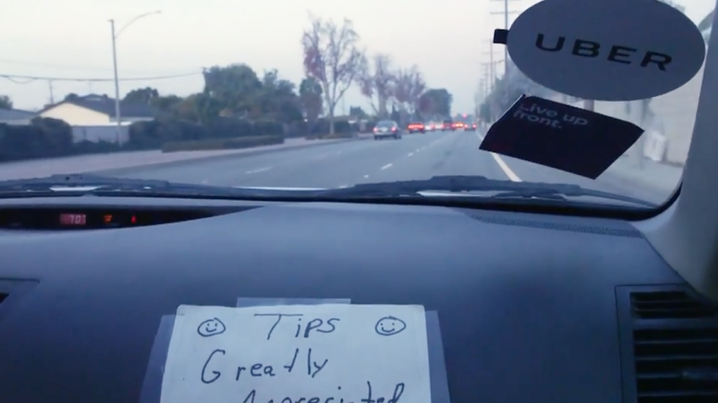 Uber Sign on Dashboard of Car