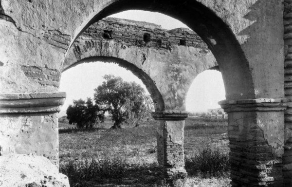 A pepper tree as seen through the ruins of Mission San Luis Rey in San Diego County. Courtesy of the USC Libraries - California Historical Society Collection.