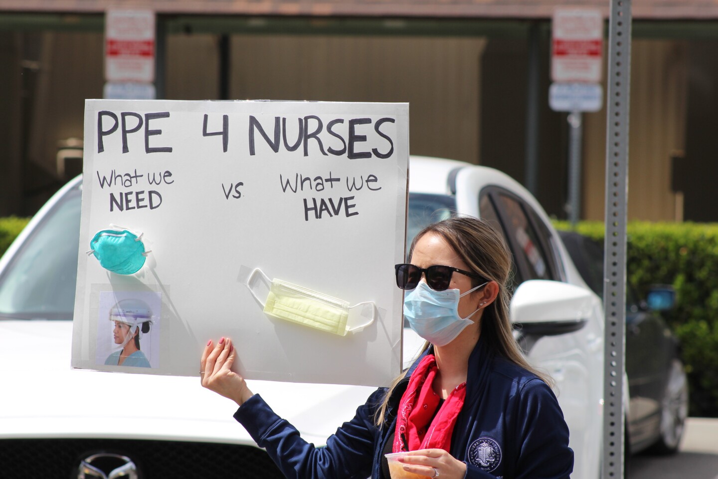 Nurse holding sign "PPE 4 Nurses", during protest outside UCI Medical Center in Orange on Friday, April 3rd | Karen Foshay