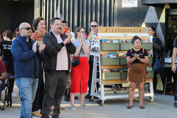 Local poet Gustavo Hernandez and book advisor Selena Pineda stand among other attendees at the first Annual LibroMobile Literary Arts Festival in 2019. | Cecilia Lopez, Courtesy of Sarah Rafael García