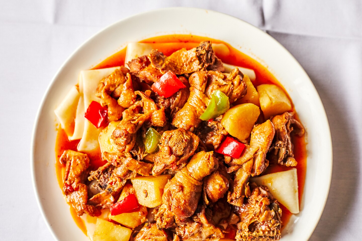 Dolan's big plate chicken is a chicken stew layered with noodles, chilies and leeks.