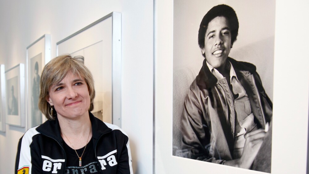 Photographer Lisa Jack poses with her photos of "Barack Obama The Freshman" at the M + F Fine Arts gallery in West Hollywood in 2009. | Photo by Damian Dovarganes/Associated Press