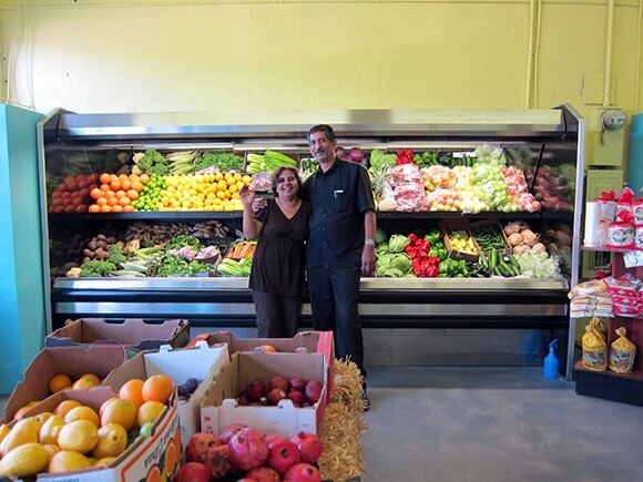 Storeowners Kulwant and Balwinder Songu in front of their new produce case at Yash La Casa Market.