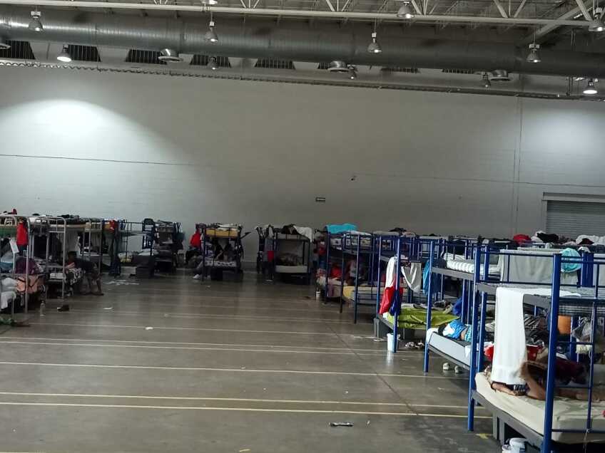A row of bunkbeds in a converted Mexican factory, which now serves as a migrant shelter