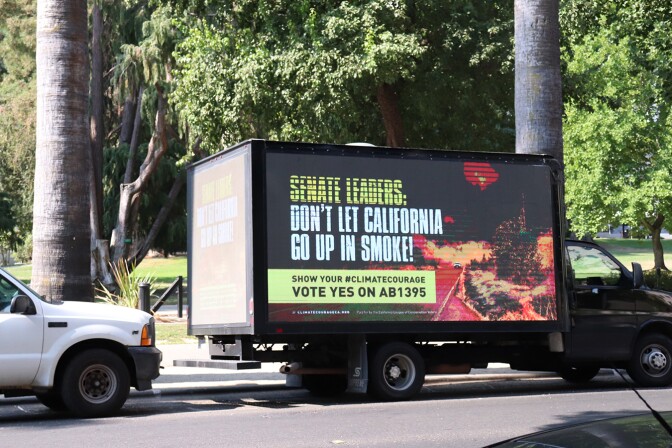 A truck parked outside the state Capitol with a sign that reads "Senate leaders, don't let California go up in smoke!"