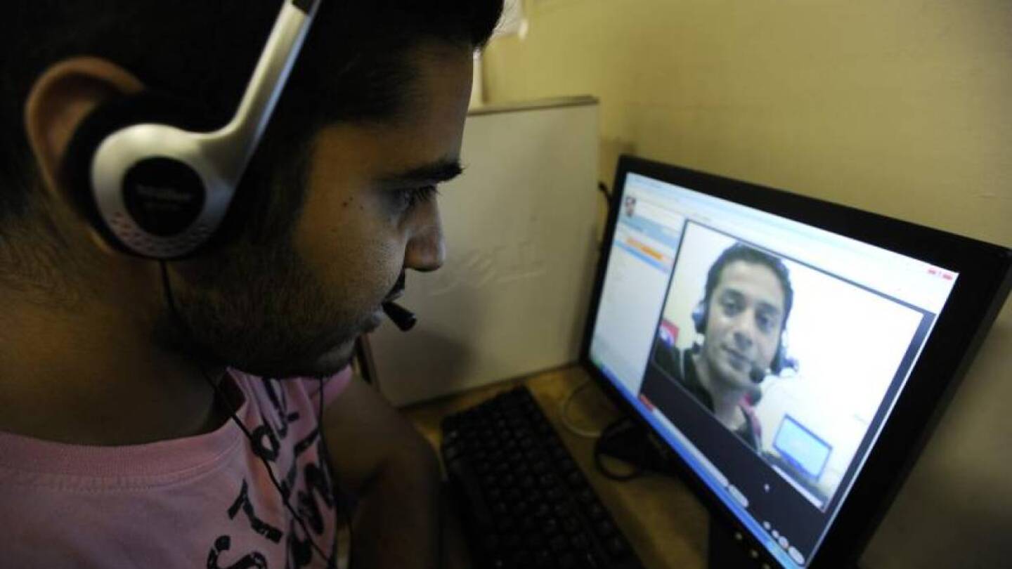 RCHIVE PHOTO: A man speaks to his friend using Skype at an internet cafe in central London August 10, 2010. | REUTERS/Paul Hackett