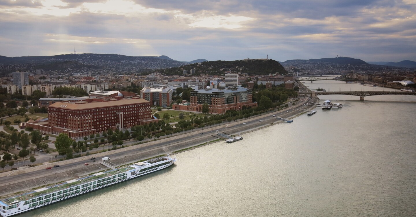 A stretch of buildings alongside a river in Budapest.
