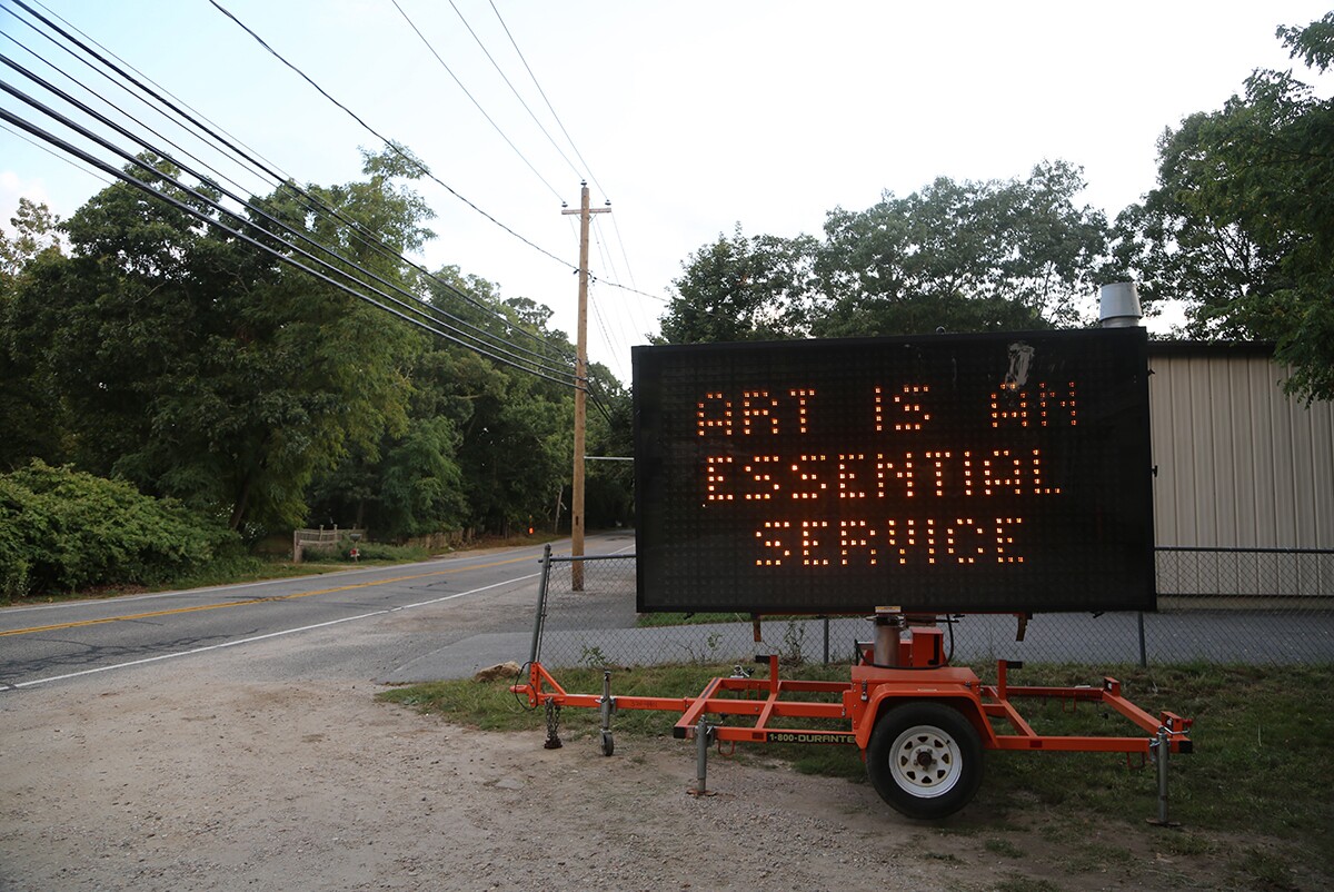 A highway sign that says “Artists are Essential Workers" outside the Fireplace Project placed by Warren Neidich | Courtesy of the artist