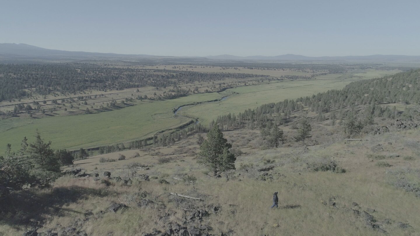 Ray Alvarez walking through open land along the Pit River. | Still from "Tending Nature"