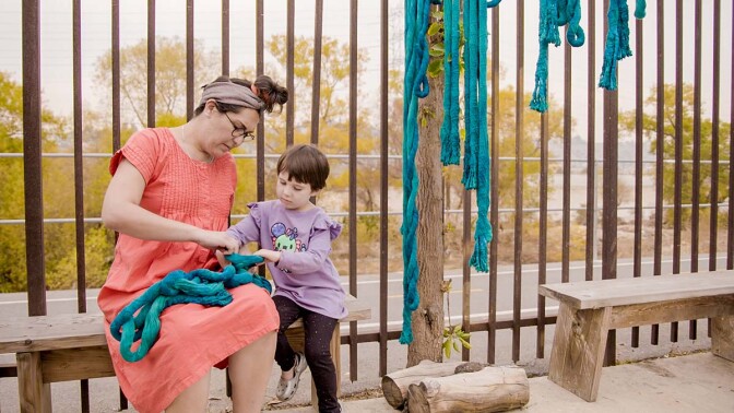 Artist Tanya Aguiñiga with her child, Io | Still from KCET Artbound's "Artist and Mother" Mother AB s9