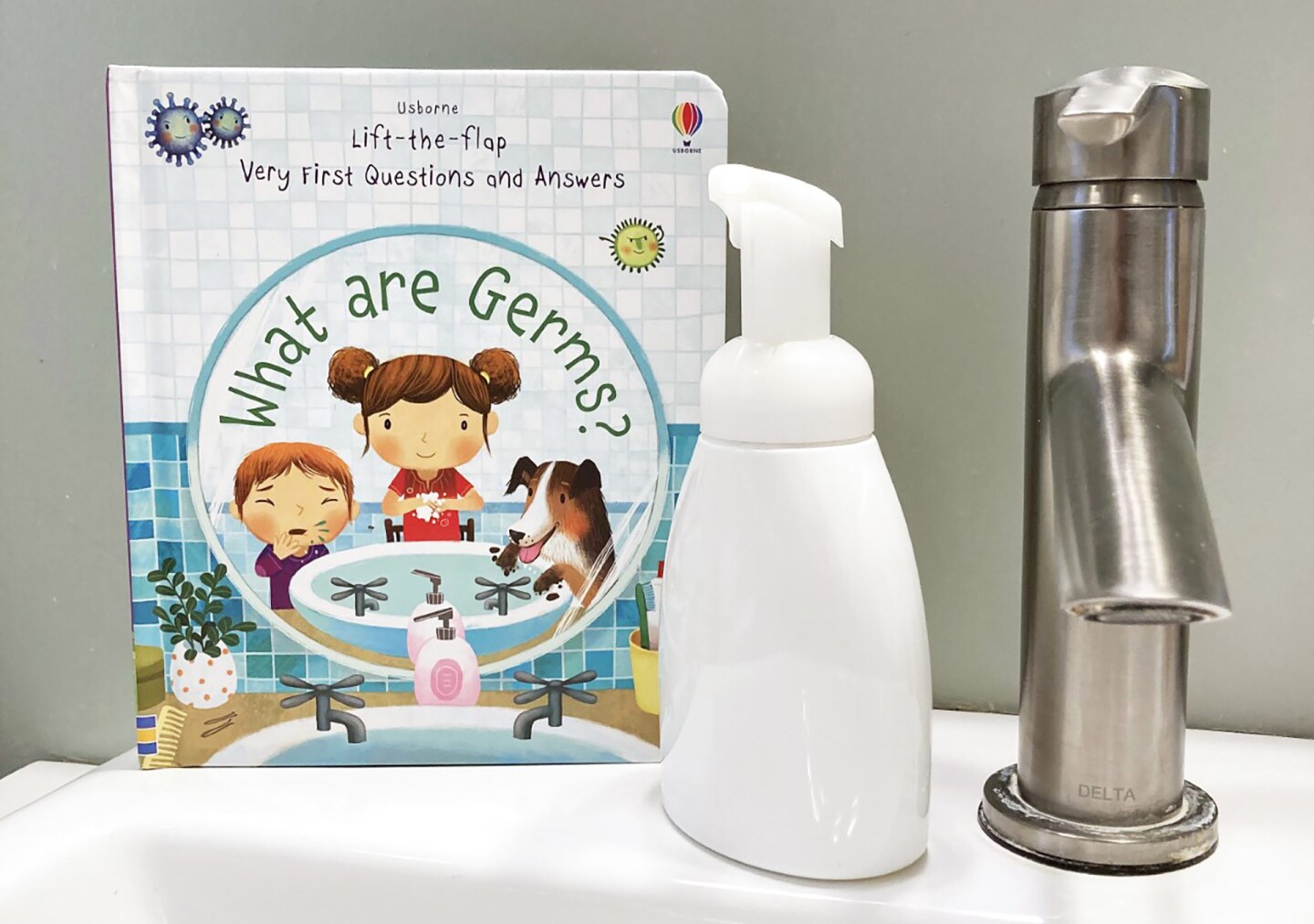 Pandemic kid book next to hand soap and faucet