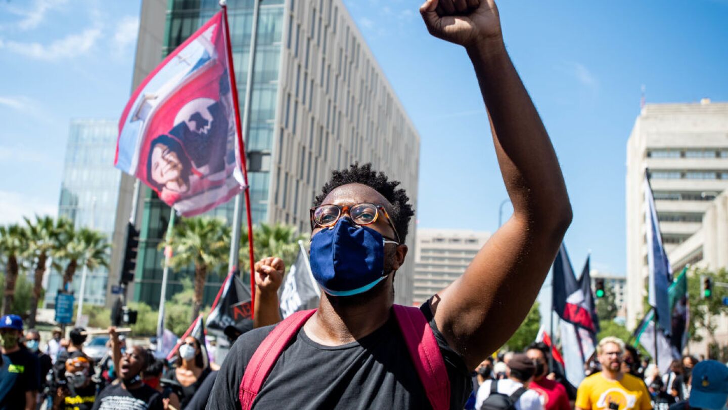 Black Lives Matter supporters march through downtown Los Angeles on the first anniversary of George Floyd's death on Tuesday, May 25, 2021.