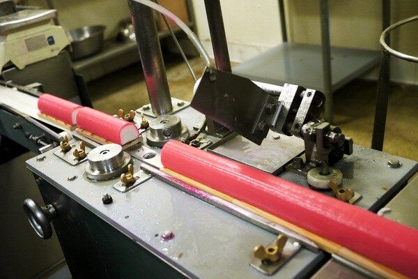 A machine slices kamaboko to its proper length at the Yamasa Enterprises facility near Little Tokyo | Photo by Yosuke Kitazawa