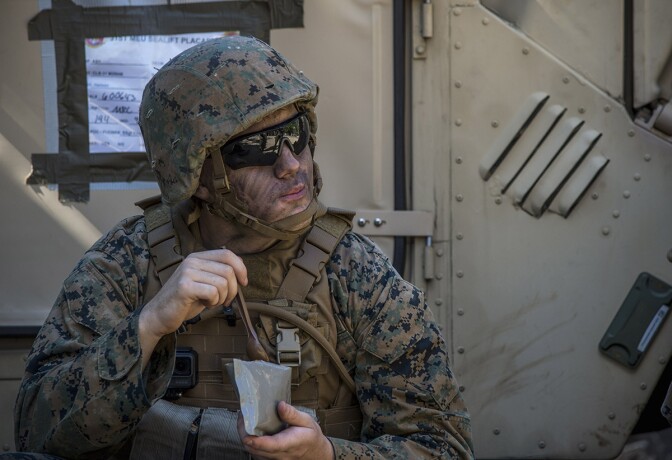 Lance Cpl. Noel Boyland, from Caseyville, Ill. eats an MRE | U.S. Navy photo by Mass Communication Specialist 2nd Class Sarah Villegas/Released