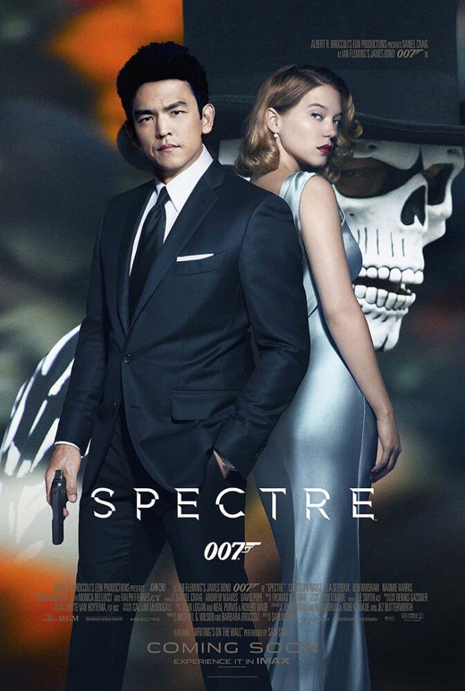 Movie poster featuring an Asian American with a gun in a suit standing in front of a blonde woman in an evening dress.